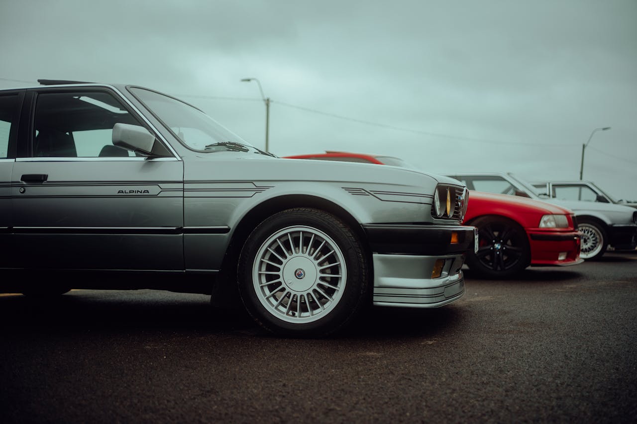 A row of cars parked in a parking lot